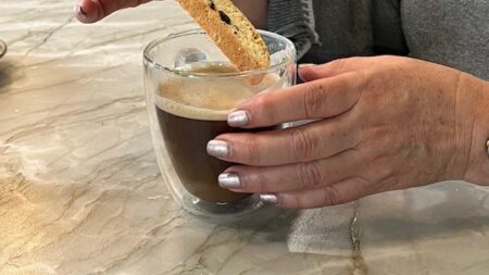 Biscotti being dipped into a cup of coffee